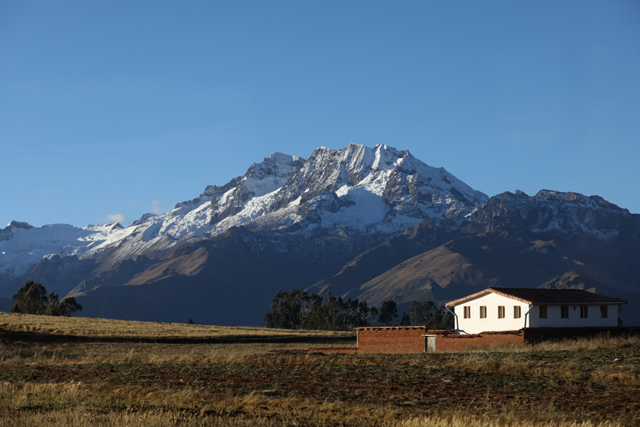Nat Geo Expeditions - Tierra Sagrada Incas - White mountains and a house